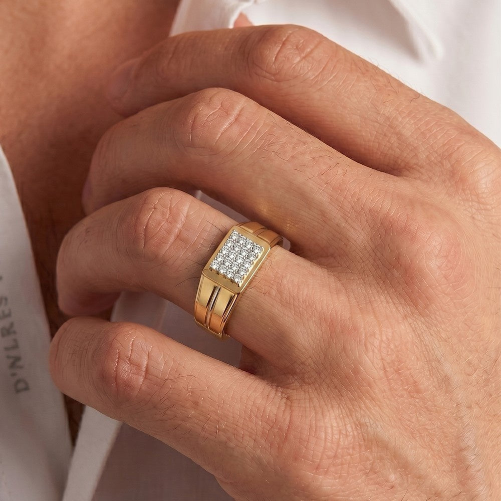 Gold ring with diamonds on a person's finger against a white background