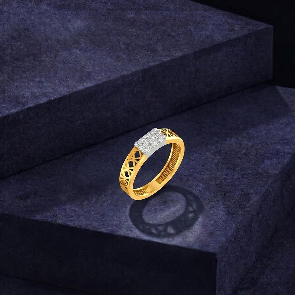 Gold ring with diamond accents on a dark blue textured surface.