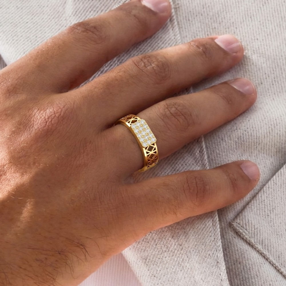 Gold ring with diamonds on a person's finger against a neutral background.