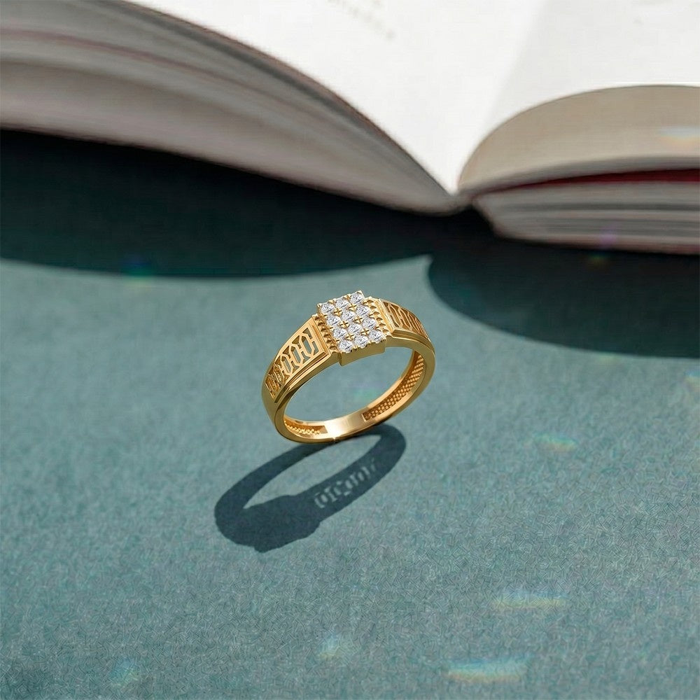 Gold ring with a diamond on a textured surface.