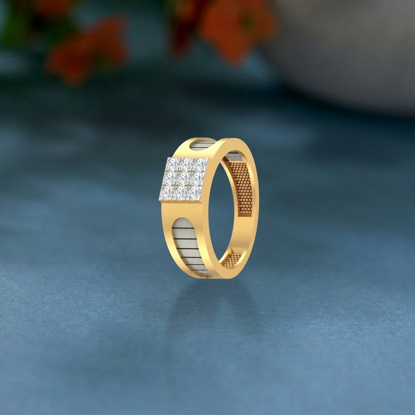 Gold ring with diamond accents on a dark blue background