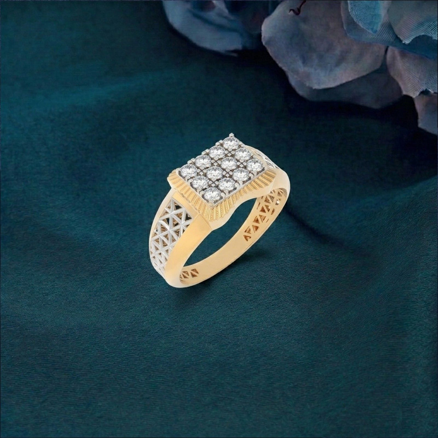 Gold ring with diamond accents on a textured green surface.