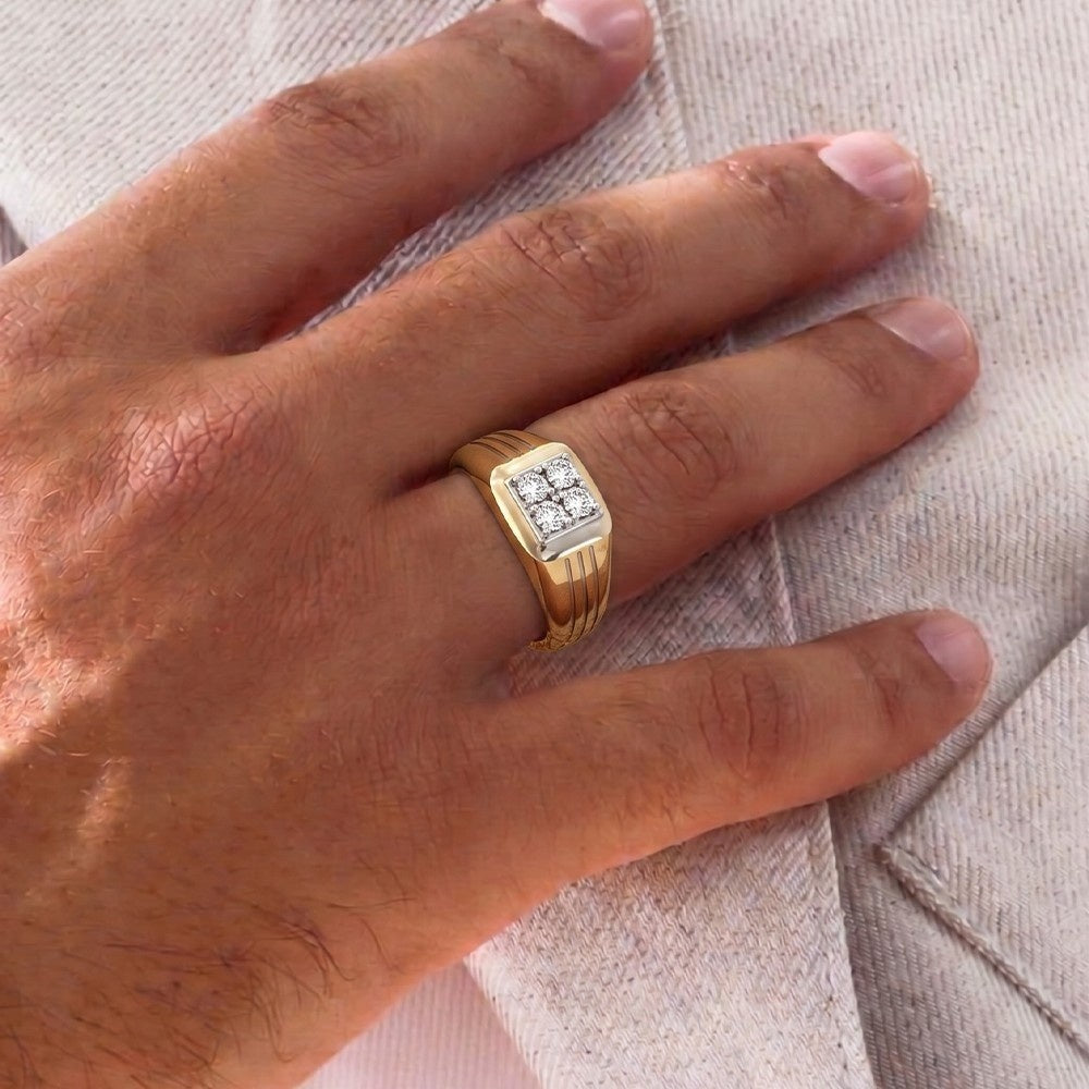 Gold ring with a diamond on a person's finger against a neutral background.