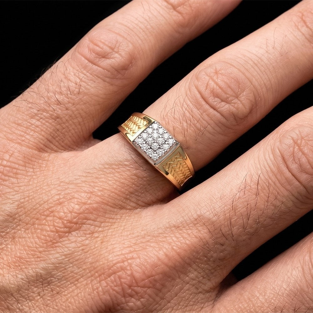 Gold ring with diamonds on a person's finger against a black background.