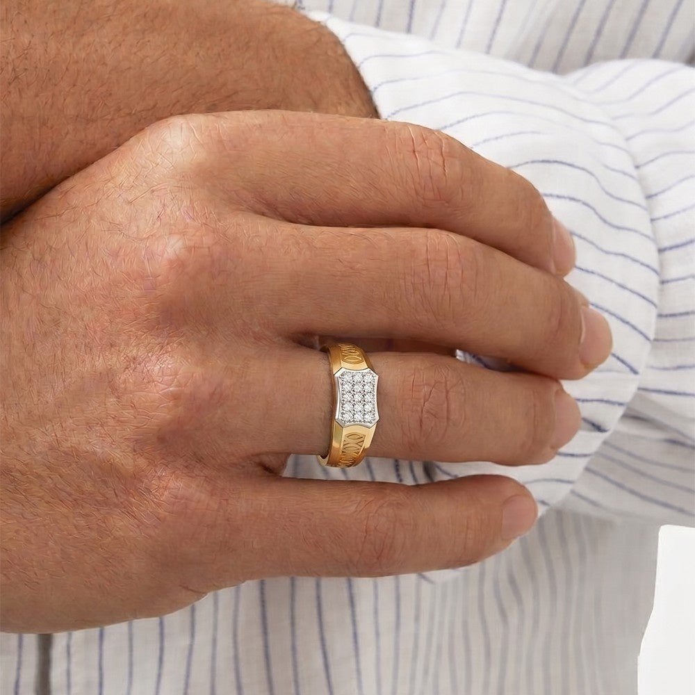 Gold ring with diamonds on a person's finger, wearing a striped shirt.