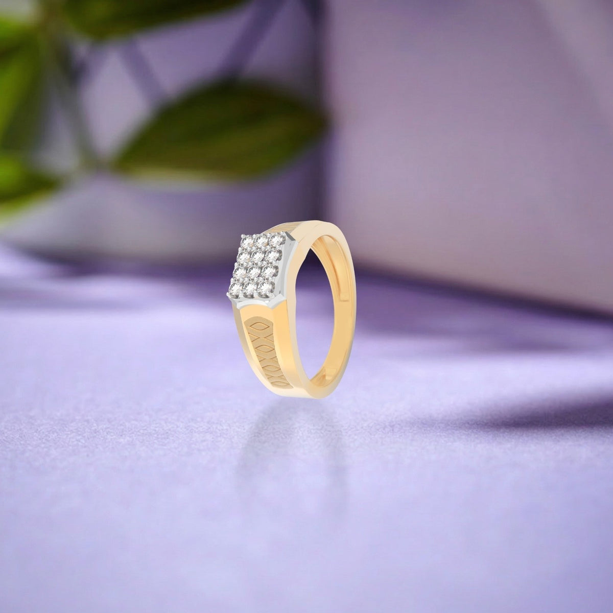 Gold ring with diamonds on a purple surface.