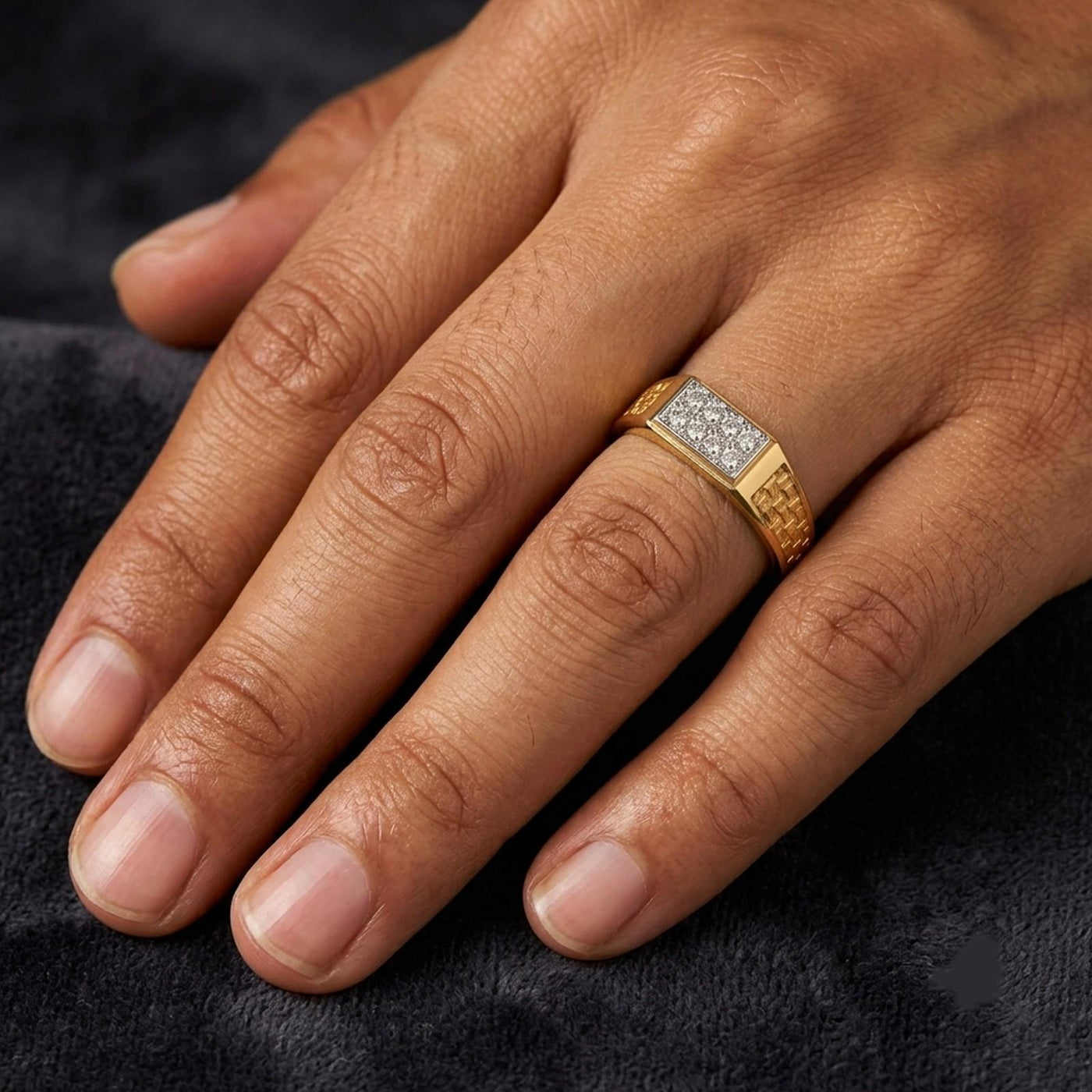 Close-up shot of a gold and diamond men's ring.