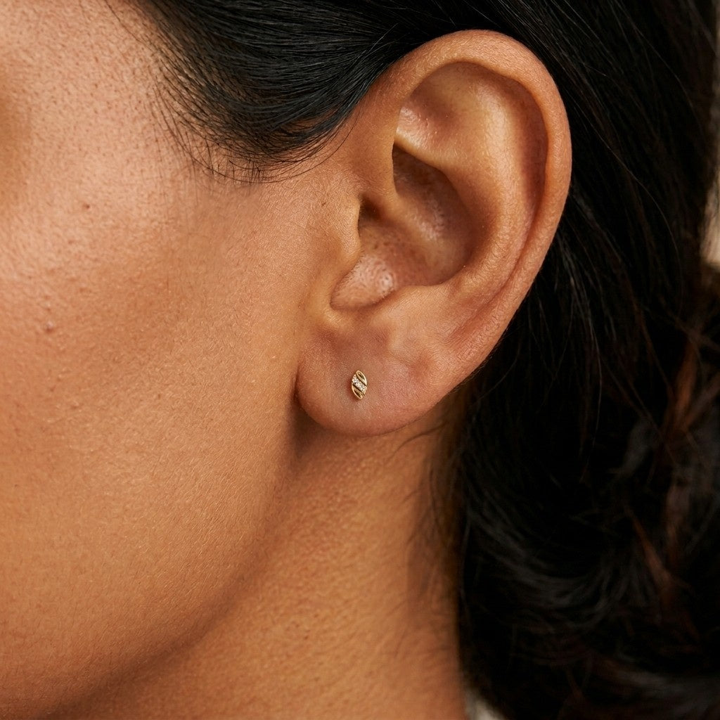 Close-up shot of a gold and diamond stud earrings.