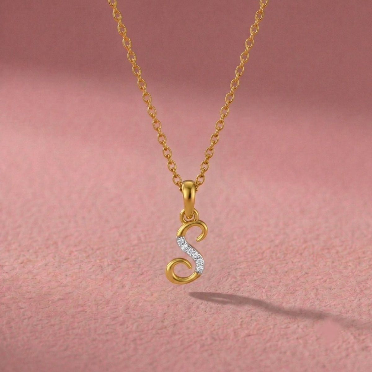 Elegant gold initial pendant with radiant diamond centerpiece.