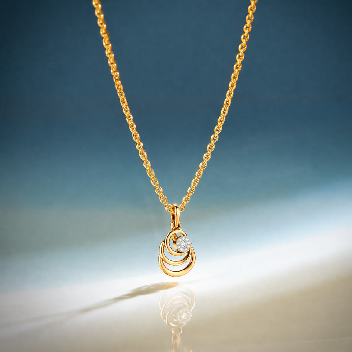 Gold necklace with a pendant on a gradient blue and beige background