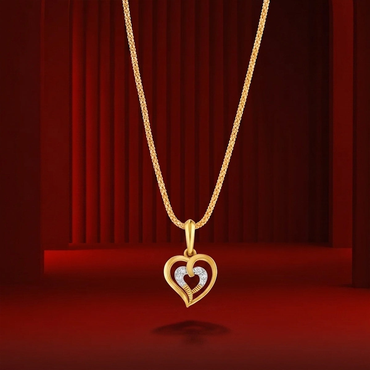 Gold heart-shaped pendant on a red background.