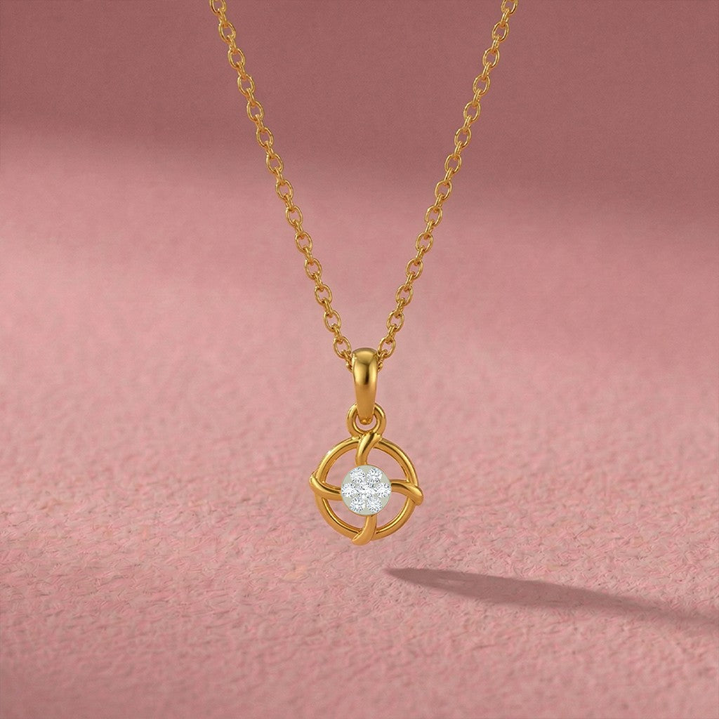 Gold and diamond pendant on a pink background