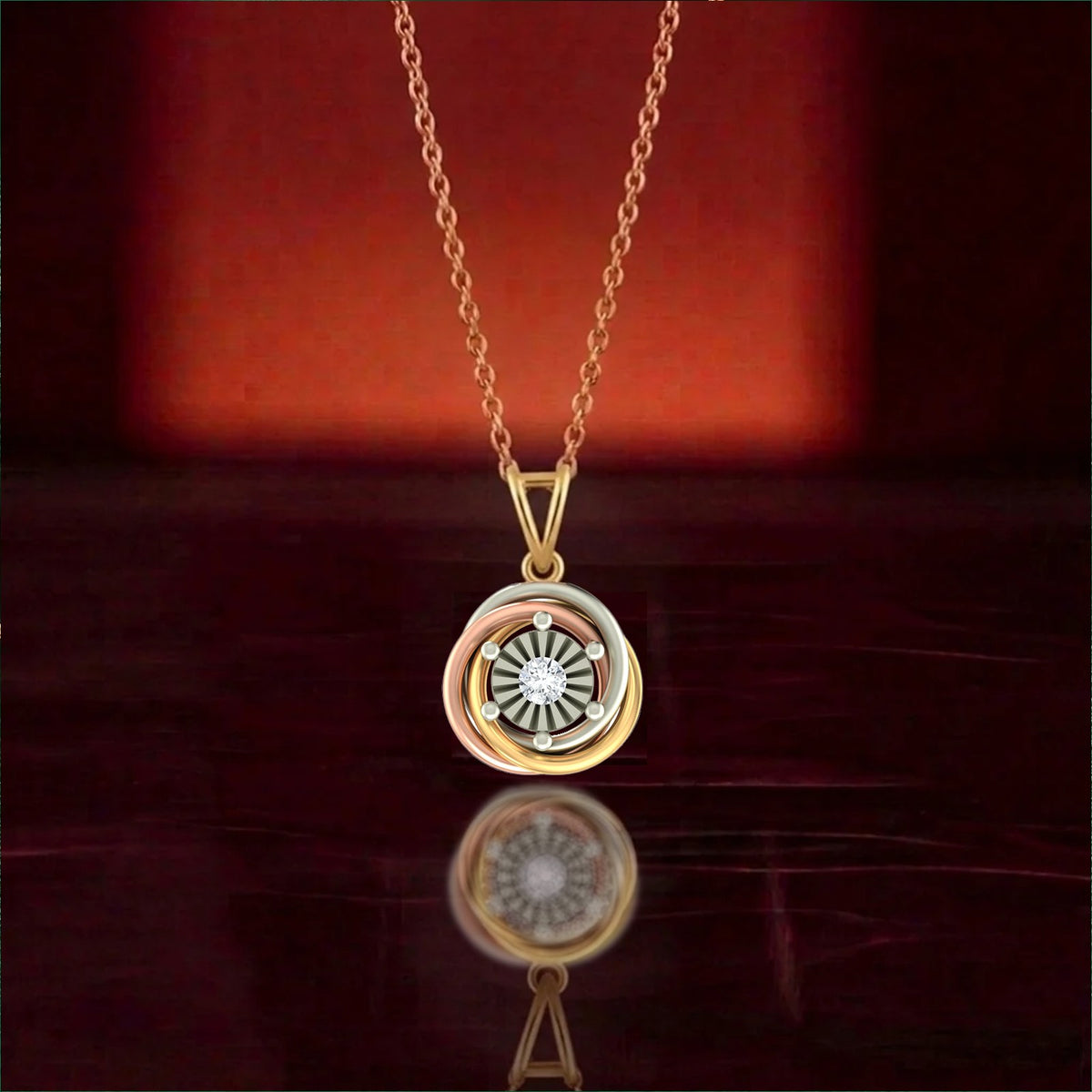 Gold and diamond tri-colour pendant on red background