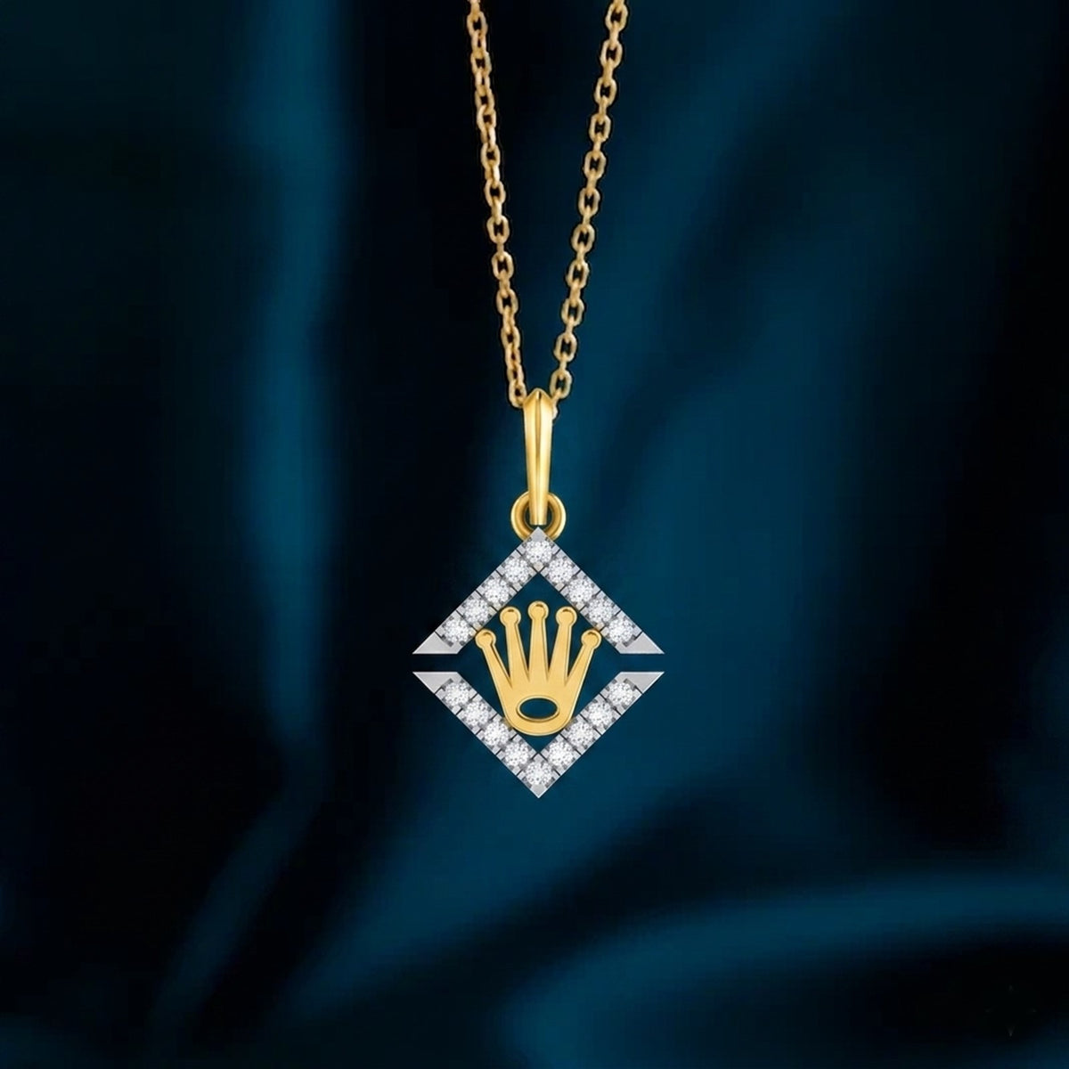 Gold and diamond pendant featuring a crown design on a dark blue fabric background.