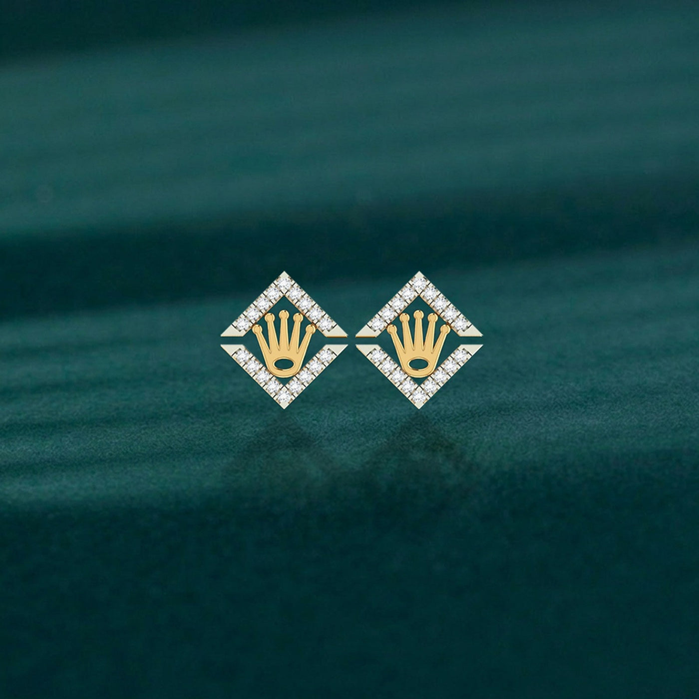 Pair of yellow gold and diamond crown-design stud earrings on a teal background.