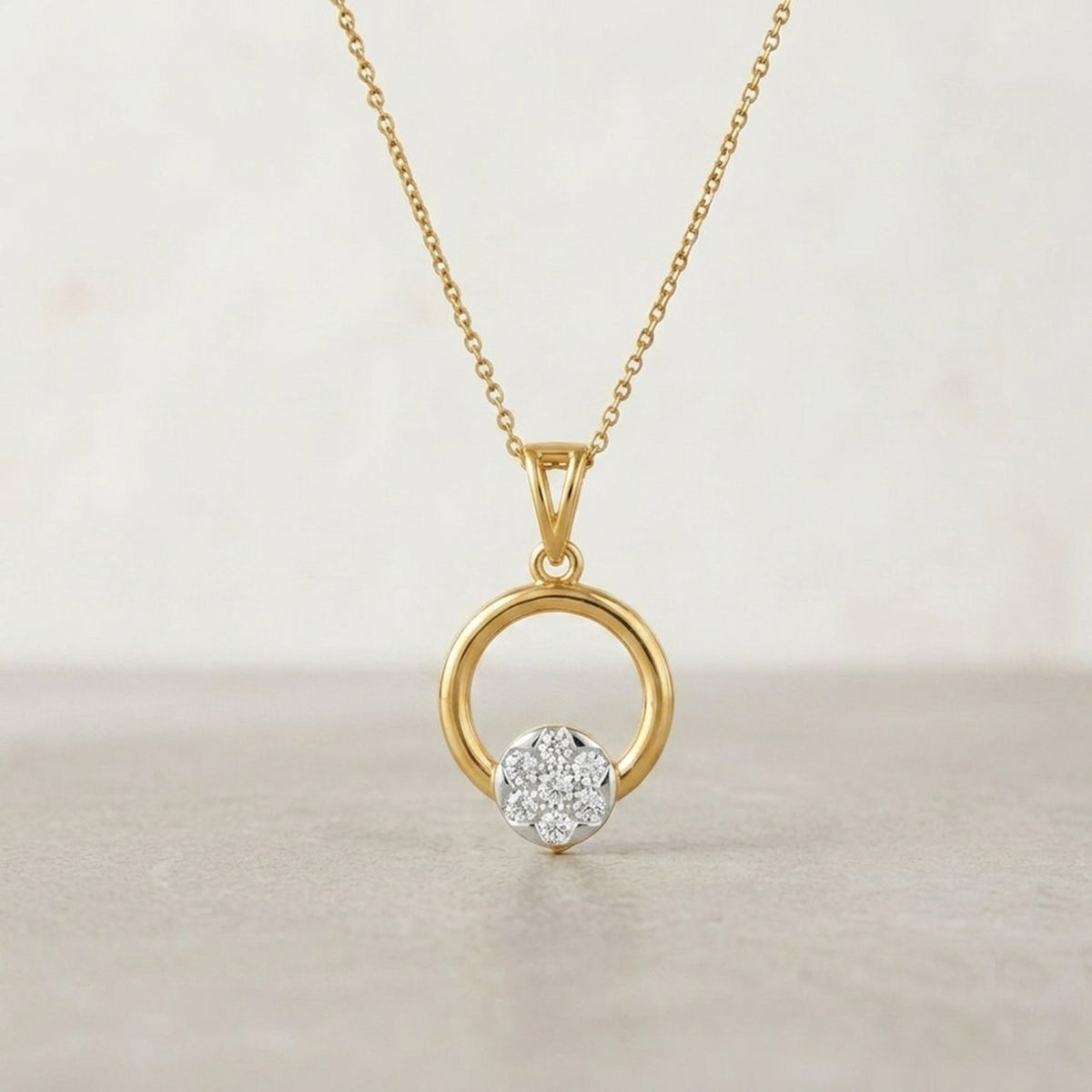 Gold with a diamond pendant on a beige background