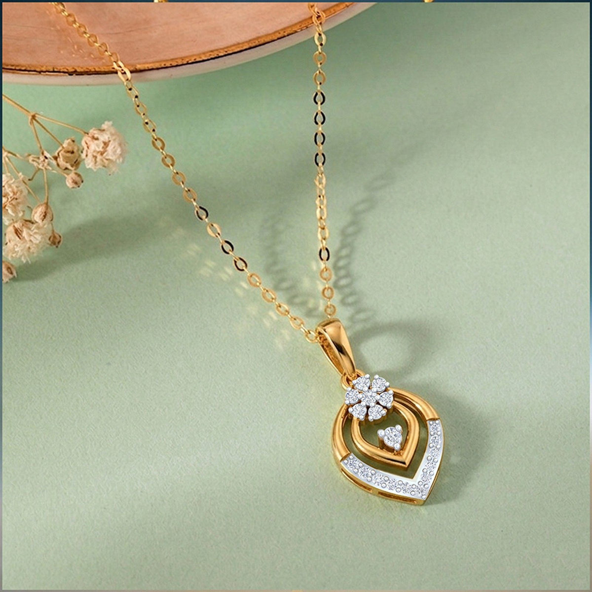 Gold and diamond with a floral-shaped pendant on a light green background