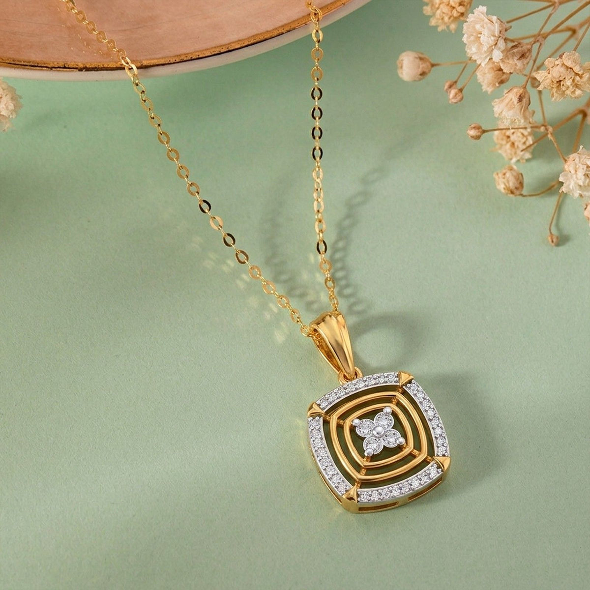 Gold with a square pendant featuring a square design on a reflective surface.