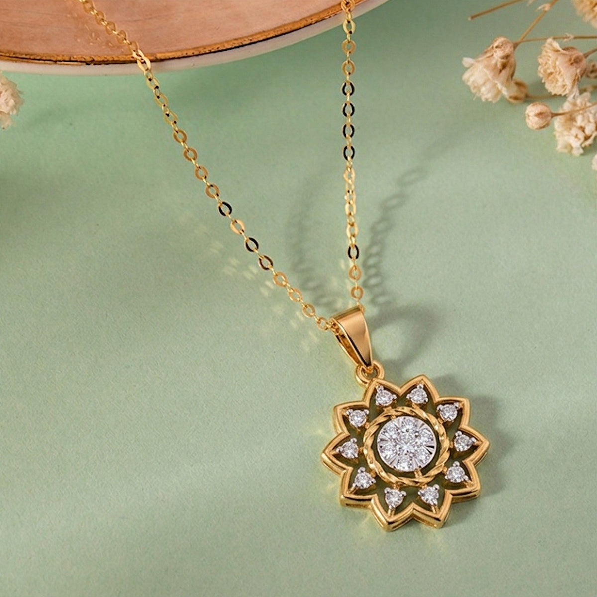 Gold and diamond pendant on a green background