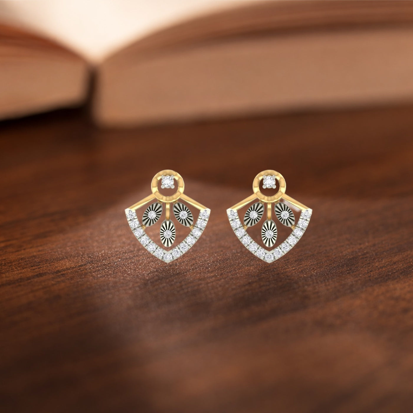 Gold and diamond earrings with diamond accents on a purple background.