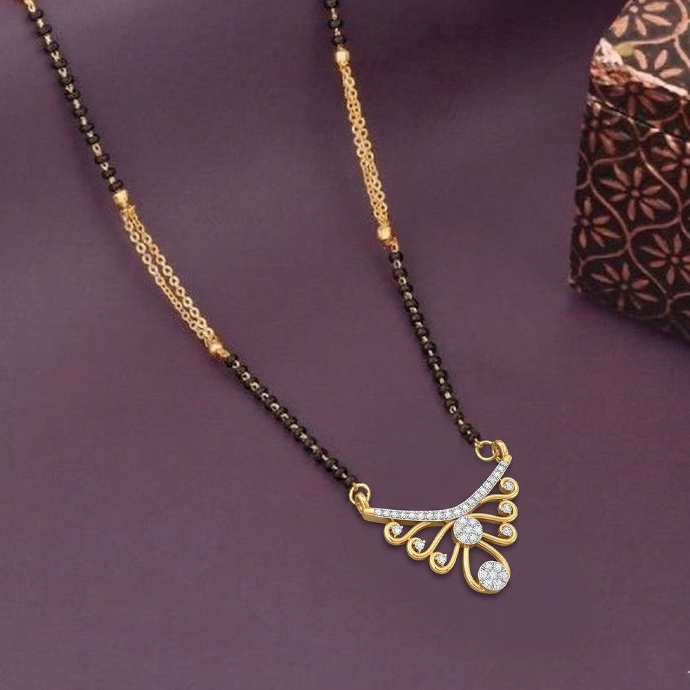 Gold and diamond mangalsutra with a decorative on a purple background