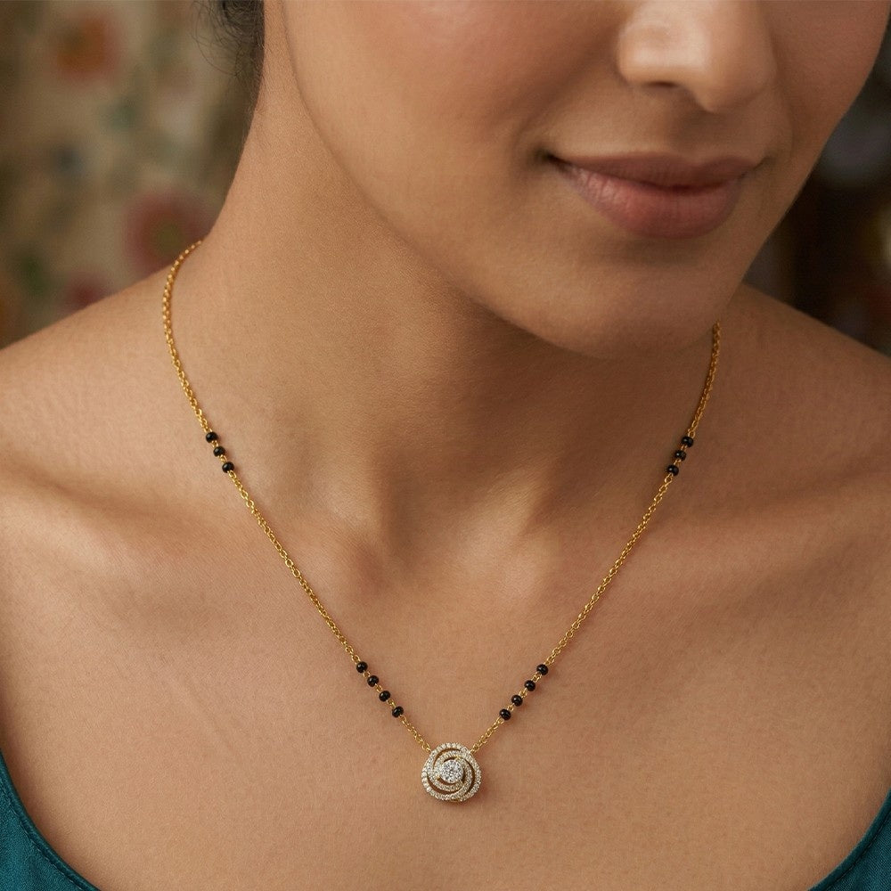Close-up of a woman wearing a gold mangalsutra.