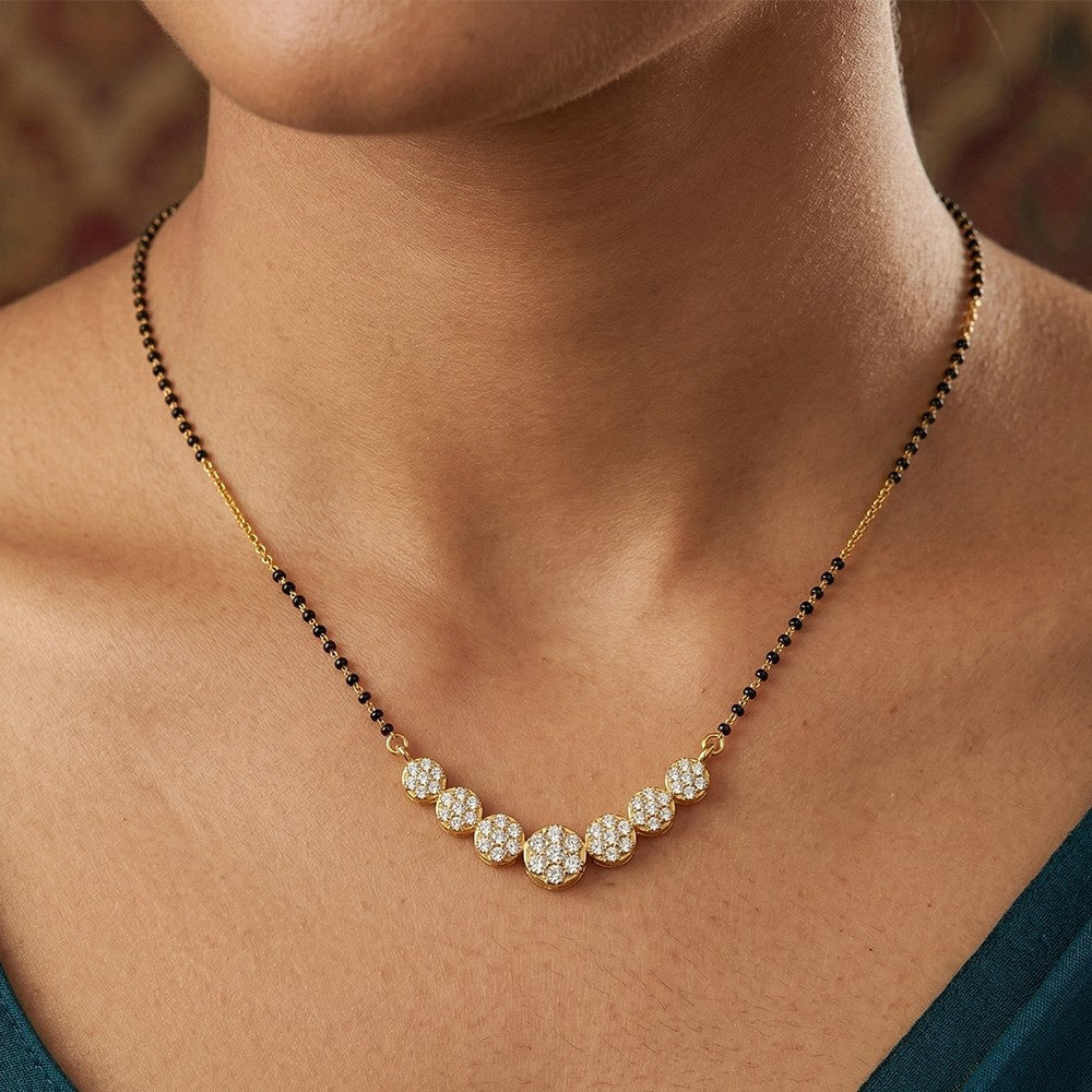 Mangalsutra with black and gold beads on a person's neck