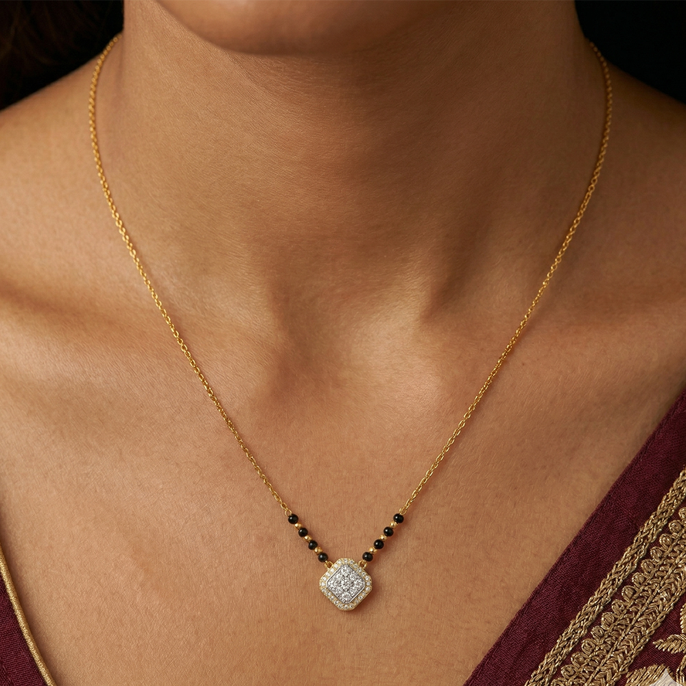 yellow gold and diamond with a diamond on a person wearing a maroon saree.