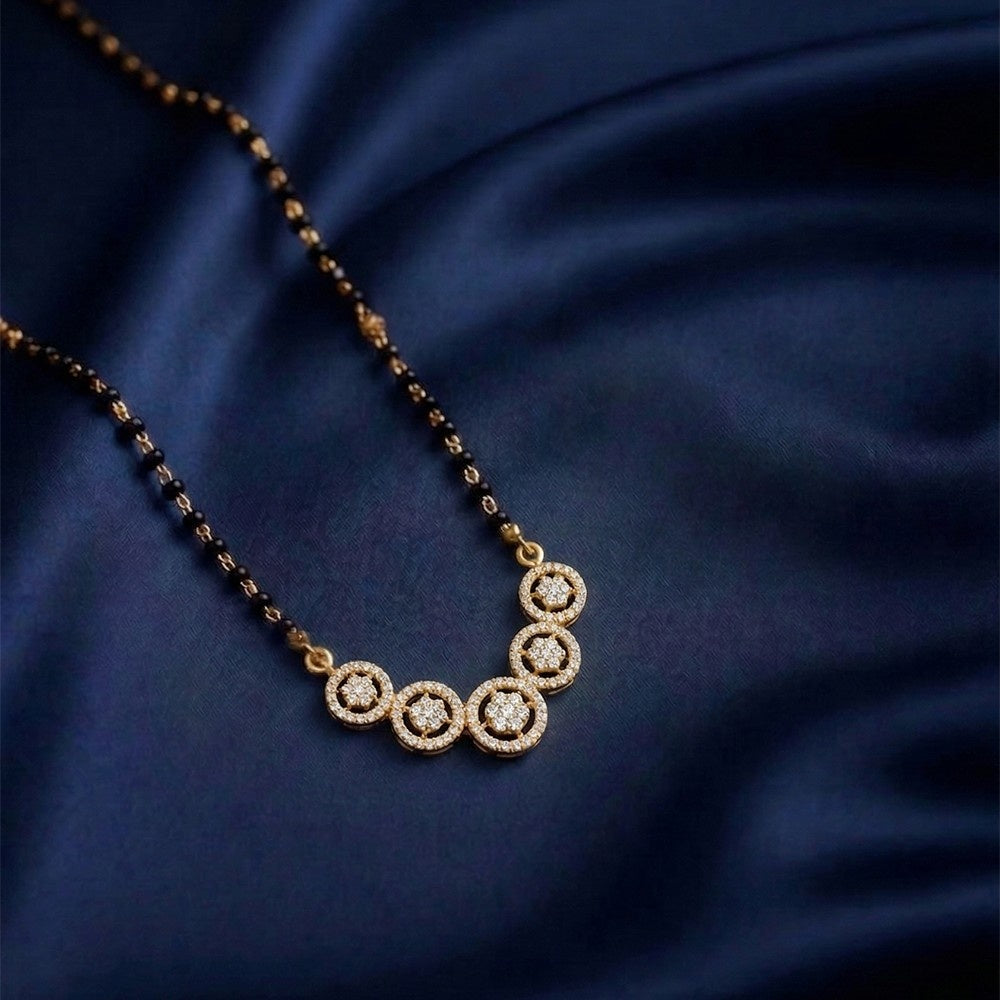 yellow Gold mangalsutra on a dark blue fabric background