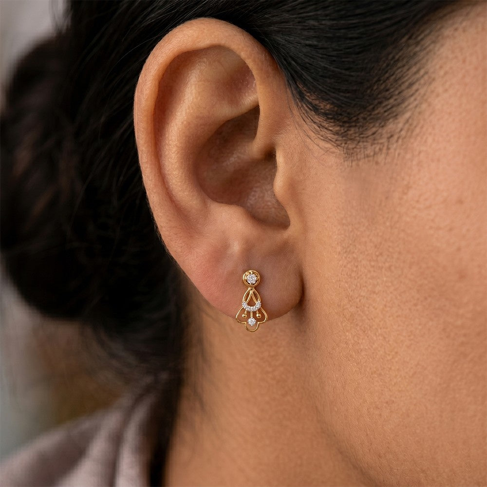 Close-up shot of a gold and diamond drop earring.