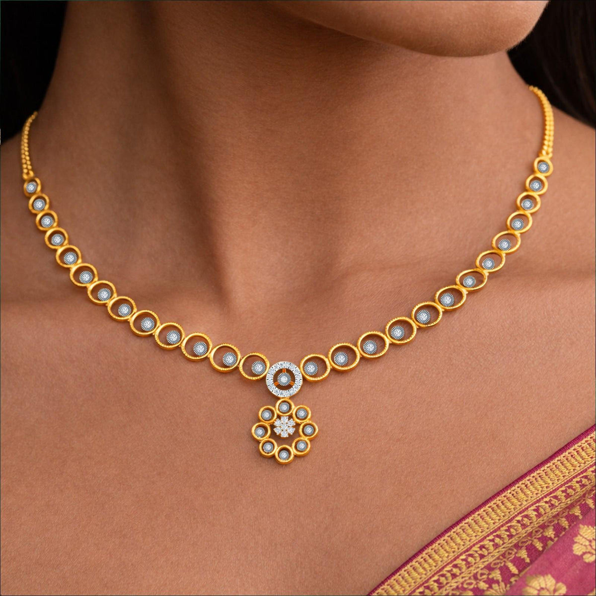 Gold and diamond necklace with circular accents, shown worn on a model's neck.