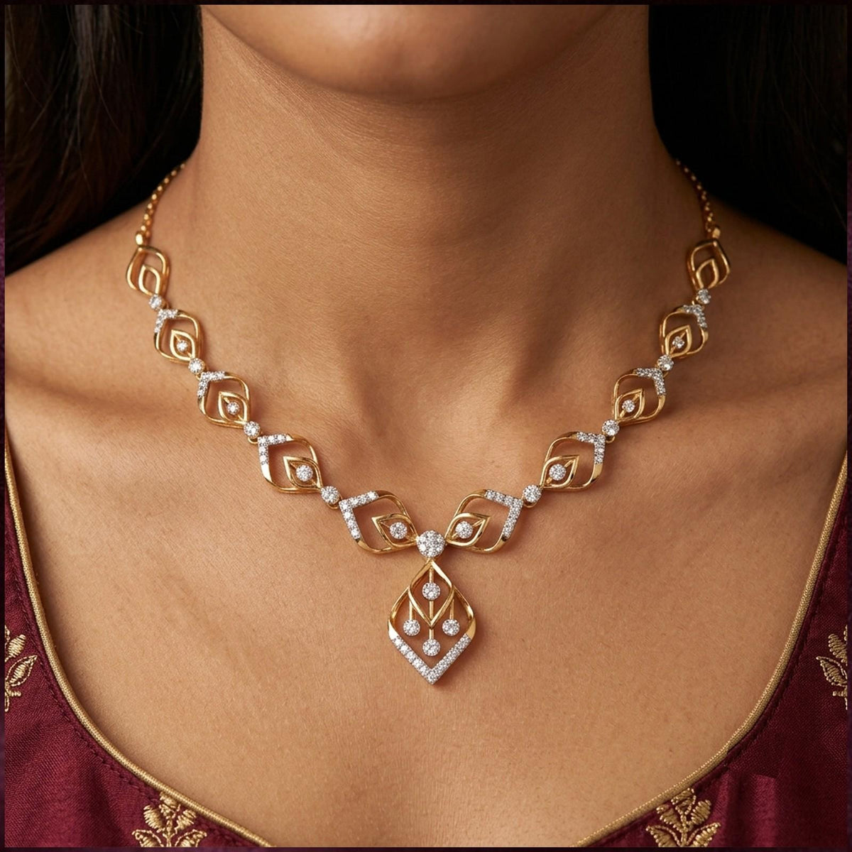 A gold and diamond necklace with a geometric pendant, shown on a model's neck.