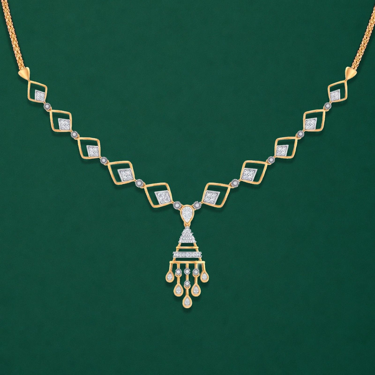 Gold necklace with diamond accents on a blue fabric background.