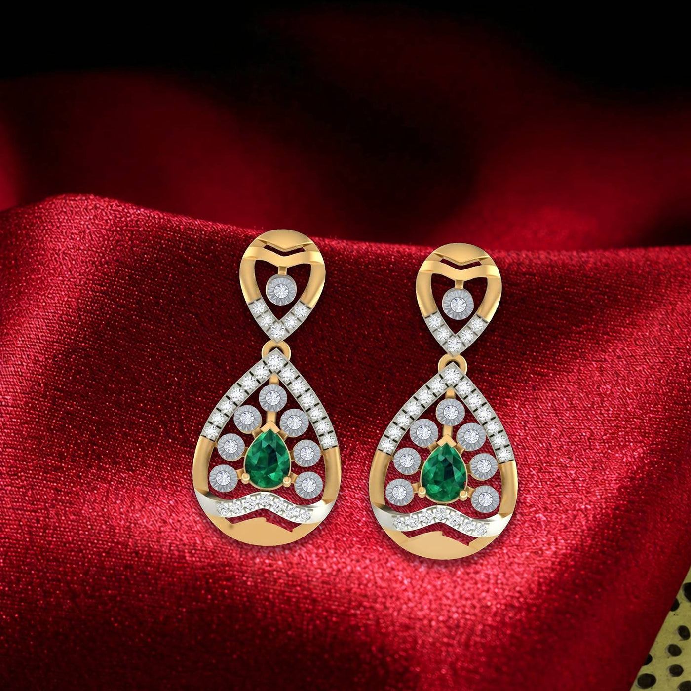 Pair of gold and diamond gemstone earrings on a red fabric background.