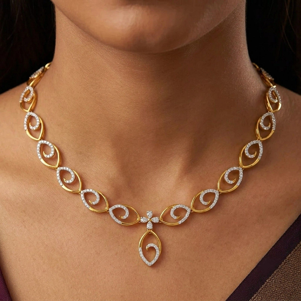 A close-up of a woman's neck wearing a gold and diamond necklace with a central floral motif.