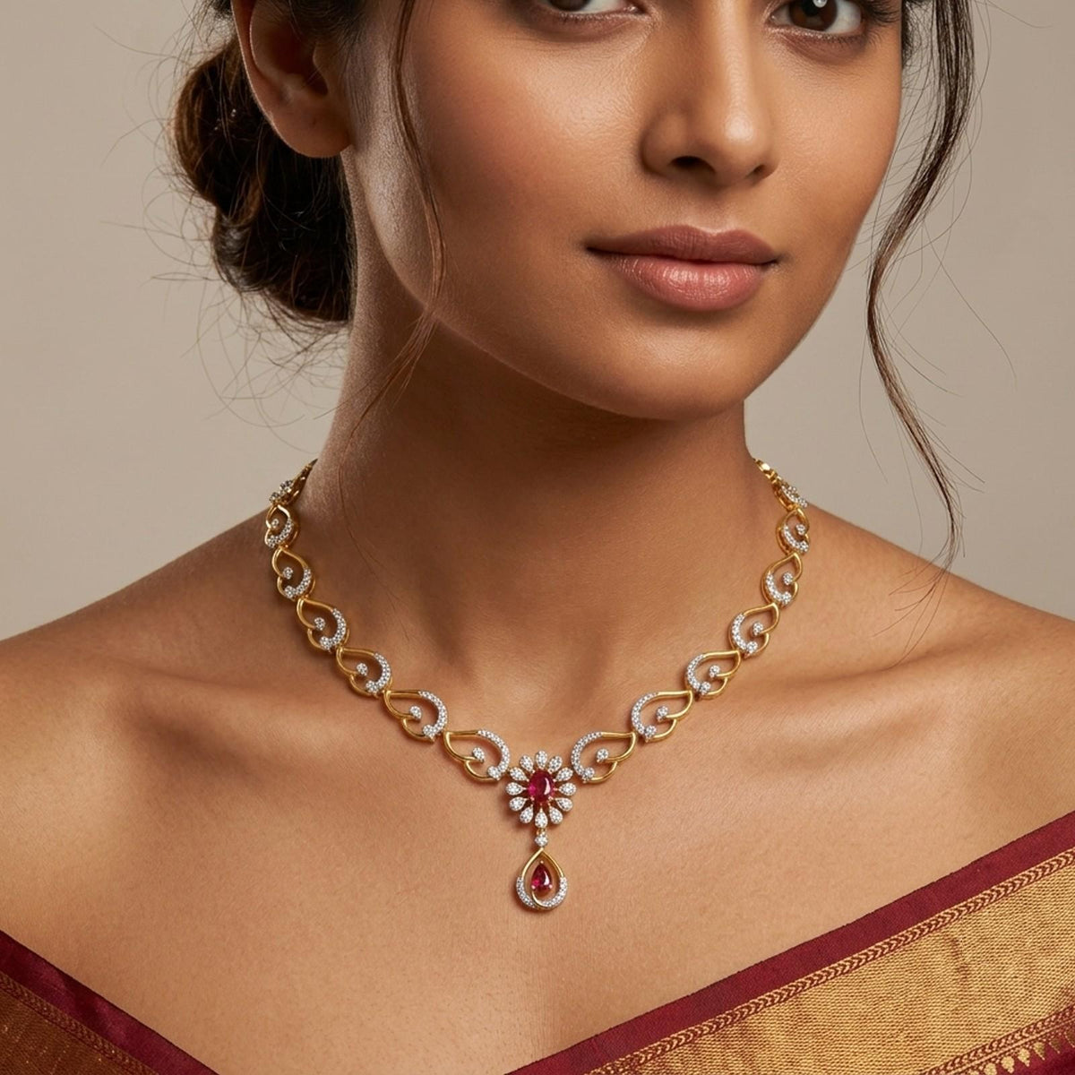 A close-up of a woman wearing a gold and diamond necklace with red gemstone accents.
