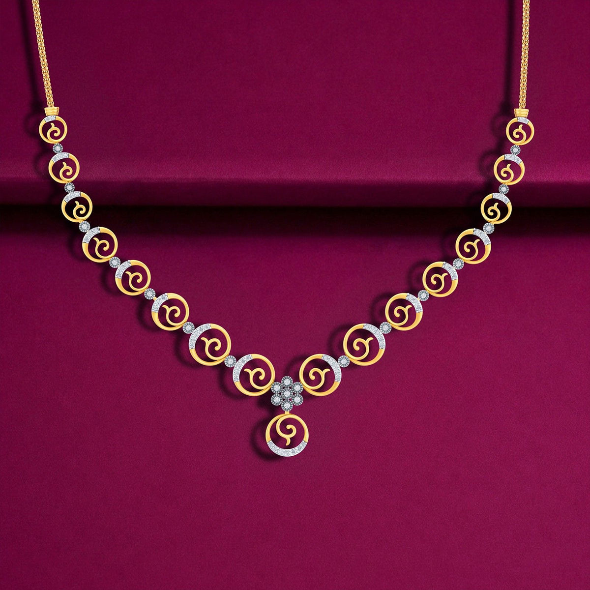 Necklace with gold and diamond spiral designs on a purple background.