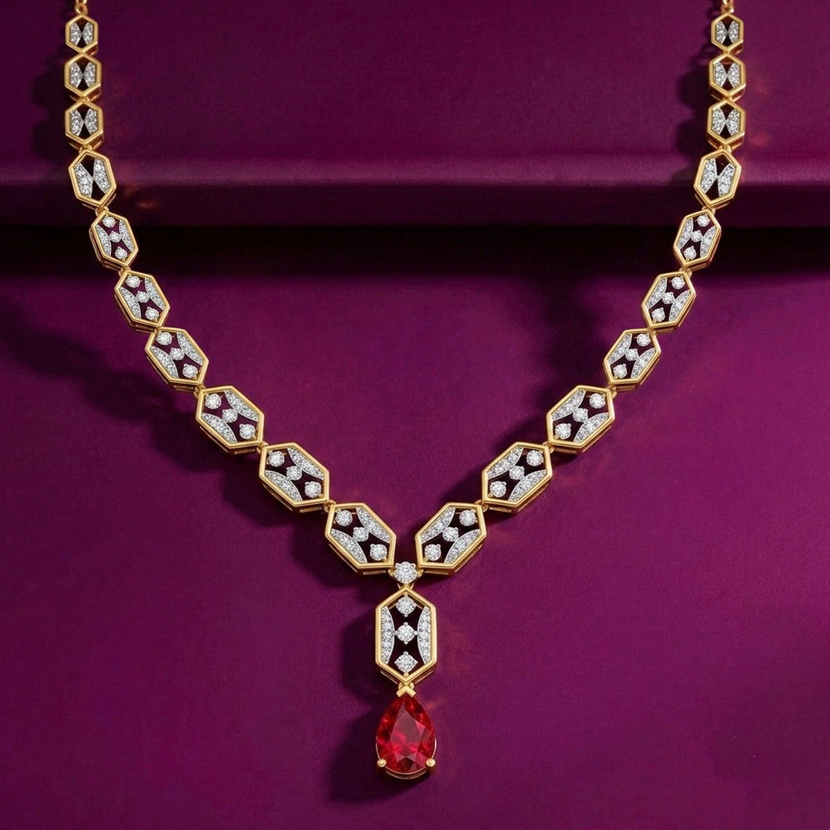 A gold geometric necklace with diamond and a red teardrop, displayed on a deep purple background.