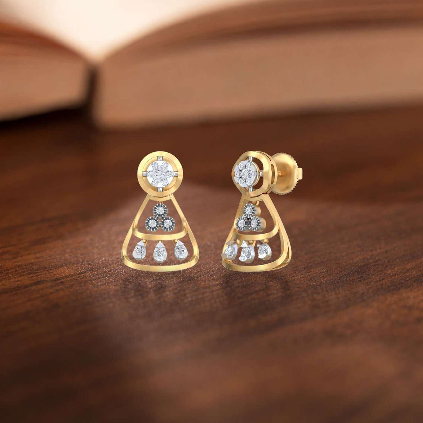 Yellow gold earrings with diamond-like stones on a brown background
