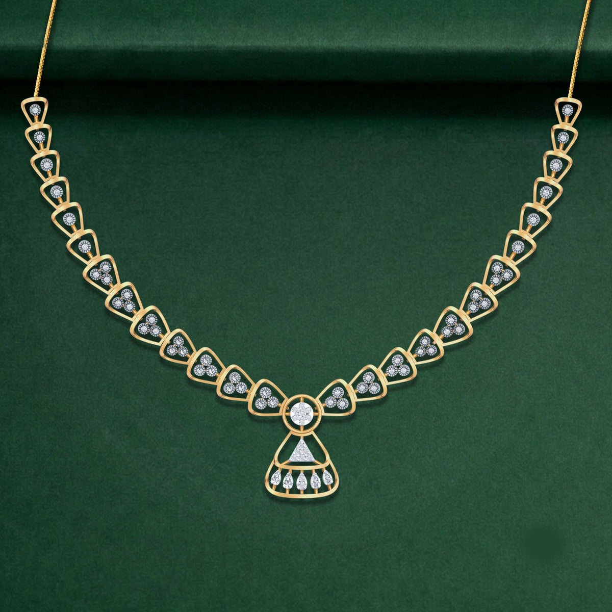 Gold and diamond necklace set, shown on a green background.