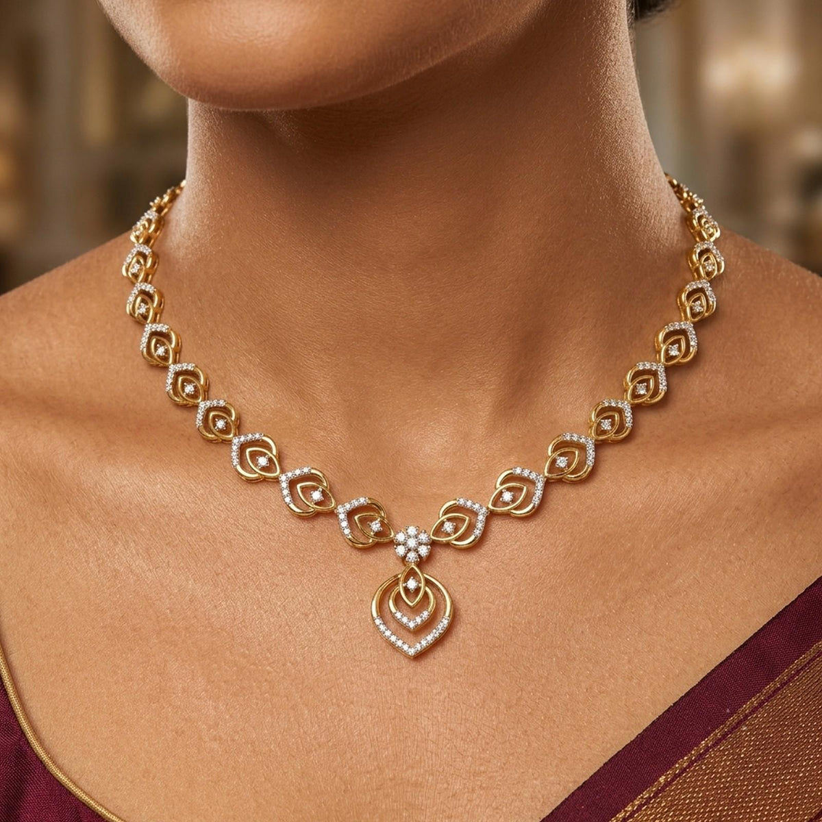 A gold and diamond necklace worn by a model, featuring a central with a floral motif.