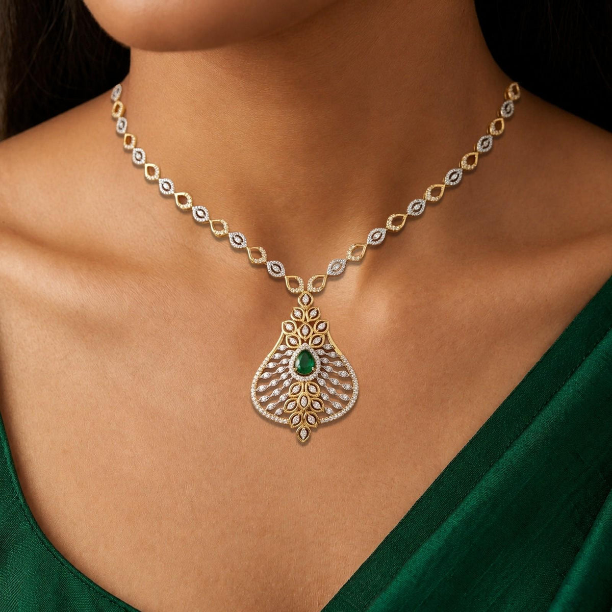 A close-up of a model wearing a gold and diamond necklace with a teardrop-shaped.