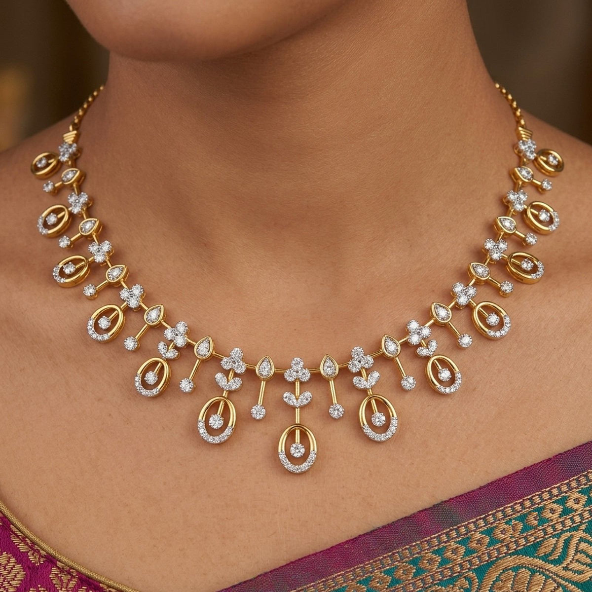 Gold necklace with floral designs on a person wearing a purple saree.