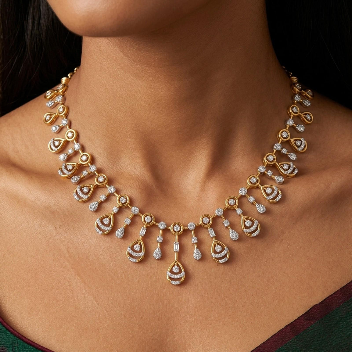 A gold and diamond necklace with teardrop-shaped, shown worn on a model's neck.