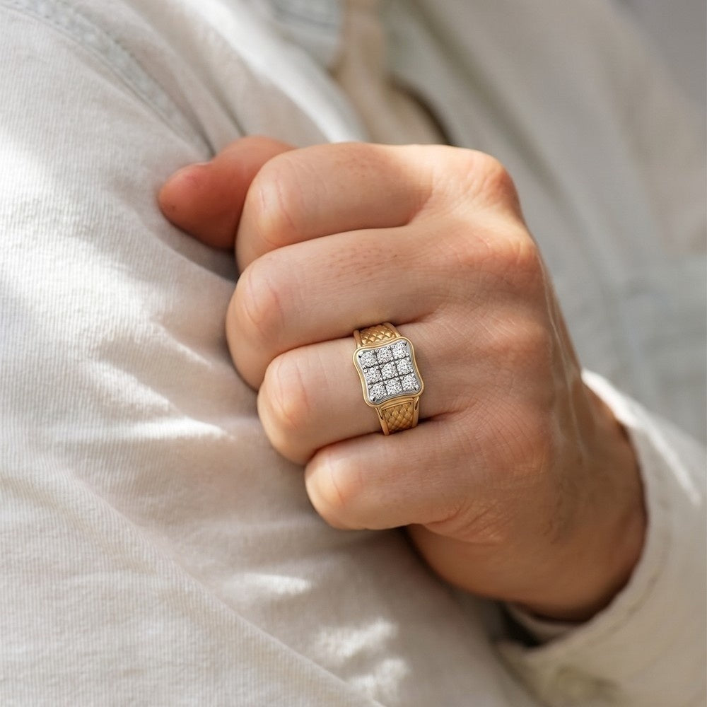 Hand wearing a gold ring with diamonds on a light background