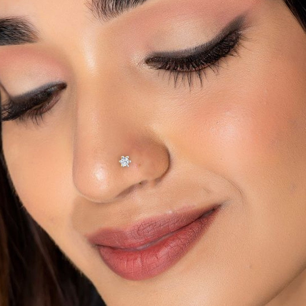 Close-up of a woman's face with a gold and diamond srud nosepin.