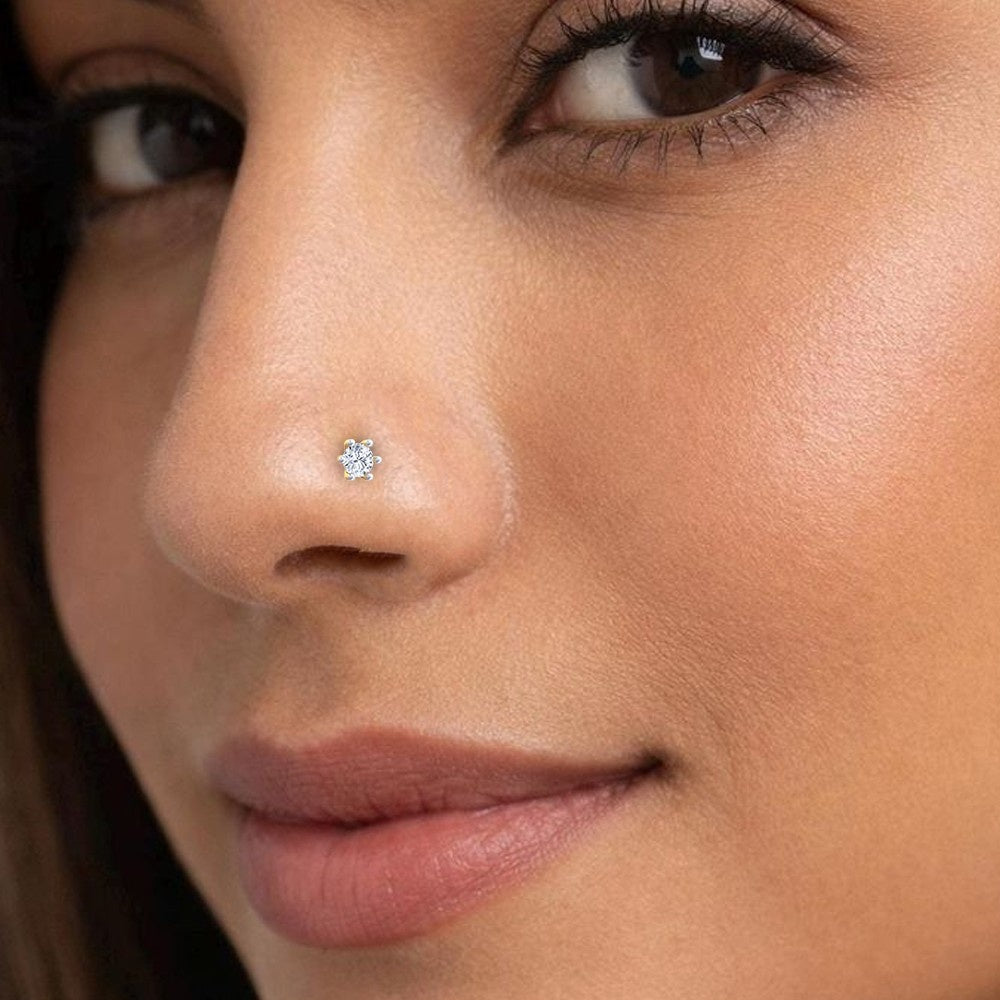 Close-up of a woman's face with a diamond nose pin.