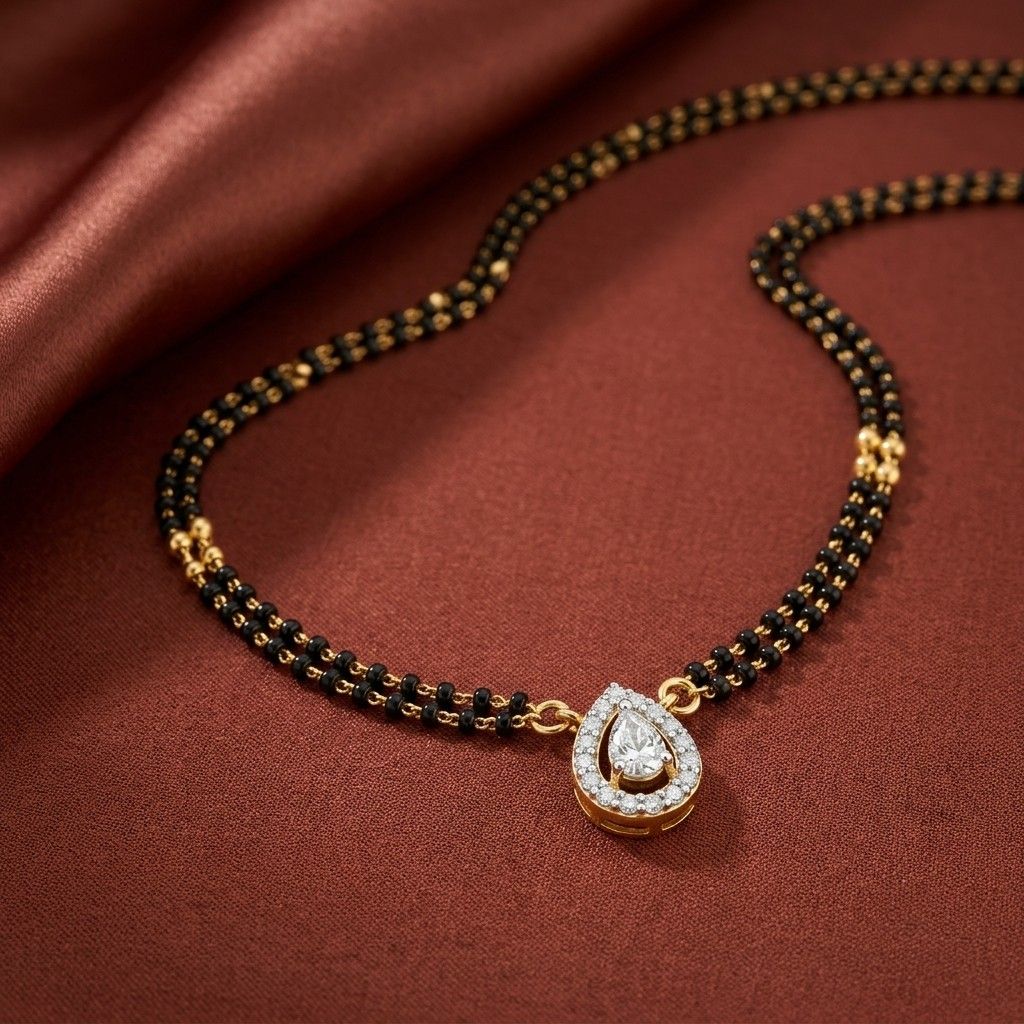 gold & diamond pear-shaped mangalsutra on a red fabric