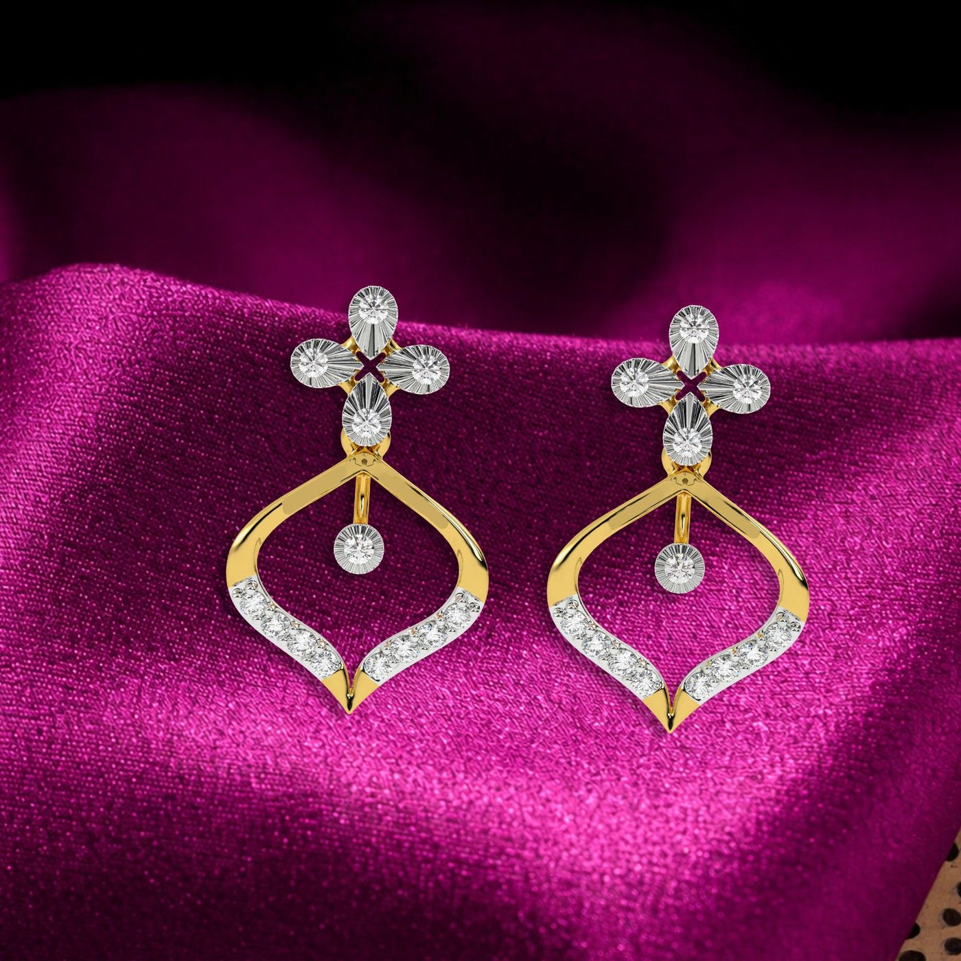 A pair of elegant yellow gold and diamond drop earrings, featuring a four-petal-shaped stud with a central diamond