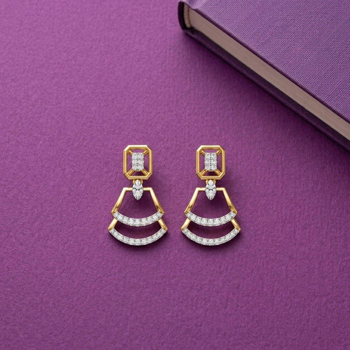 Gold earrings with diamond accents, featuring a geometric design. stones, displayed on a textured purple surface.